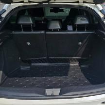 a trunk of a white car with the trunk open
