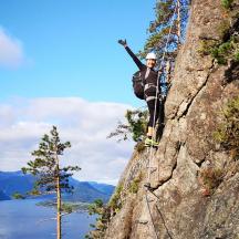 a man standing on the side of a mountain