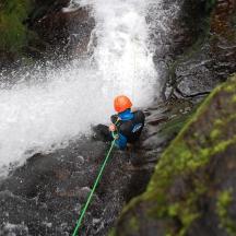 una persona està dreta davant d'una cascada