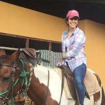 a woman sitting on top of a horse