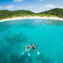 a group of people swimming in the ocean