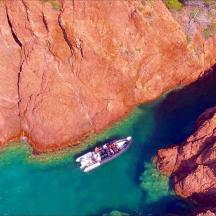 ein Boot in einem Gewässer neben einer Klippe