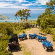 a group of four atvs parked on a dirt road