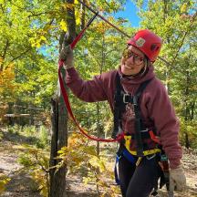 a person is tied to a tree with a rope