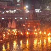 a crowd of people with lights in the water at night