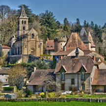 a group of houses and a church on a hill
