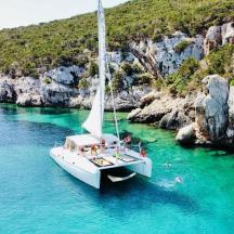a sailboat in a body of water with people on it