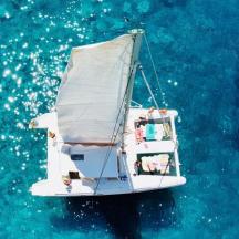 a white boat floating in the blue water