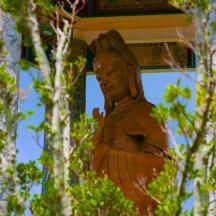 a statue of a buddha sitting on the side of a building