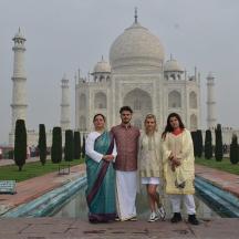 a group of people standing in front of the taj mahal