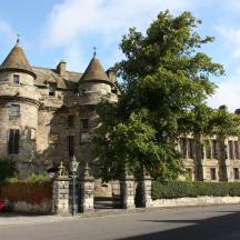 an old castle with a tree in front of it