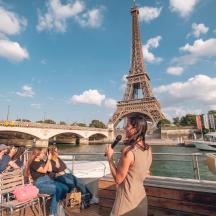 a woman on a boat in front of the eiffel tower
