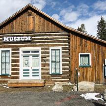 a log cabin with a sign on the front of it