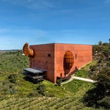 a building on top of a hill with trees
