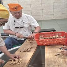 a group of people preparing food in a kitchen