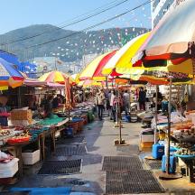 a market with many tables with umbrellas