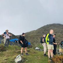 a group of people standing on top of a hill
