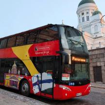 a red double decker bus parked in front of a building