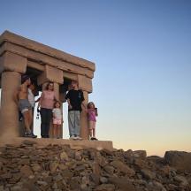 a group of people standing on top of a monument