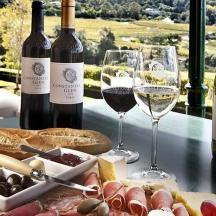 a table with two glasses of wine and food