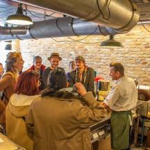 a group of people standing around in a kitchen