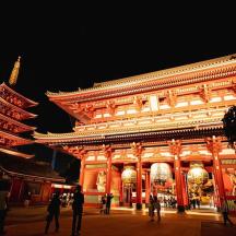 a large building with people standing outside at night