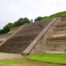 a person standing on the top of an pyramid