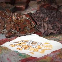 a group of figurines sitting on a table with a painting