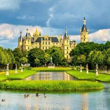 a palace with a pond in front of a building