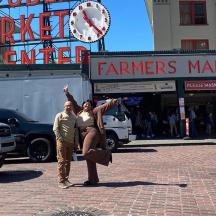 a man and a woman posing for a picture on a street