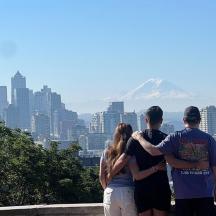a group of people standing in front of a mountain