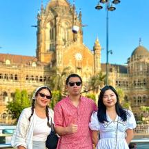 a group of three people standing in front of a building