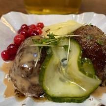 a plate of food with meat and vegetables on a table