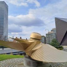 a statue of a bird in a city