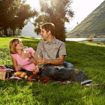 a man and a woman sitting on the grass