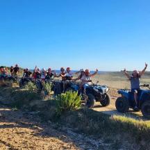 a group of people on atvs on a dirt road