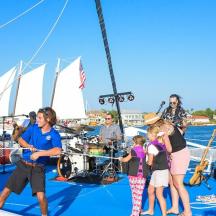a group of people standing on a sail boat