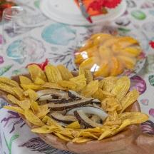 a hand holding a plate of food on a table