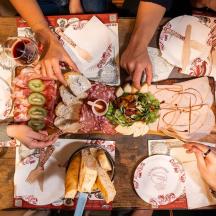 a group of people sitting around a table with food