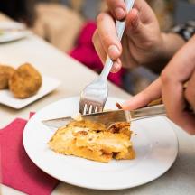 a person eating a piece of cake on a plate