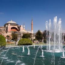 a fountain in front of a building with mosques