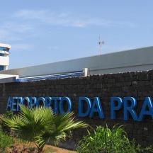 a sign on a brick wall in front of an airport