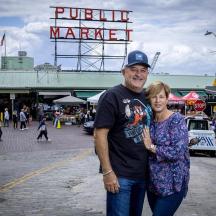 a man and a woman standing in front of a market