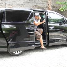 a man sitting in the door of a black van