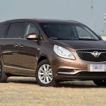 a brown suv parked in a field