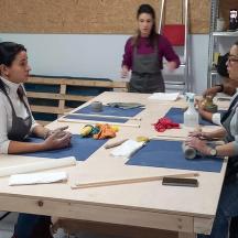 a group of women sitting at a table working