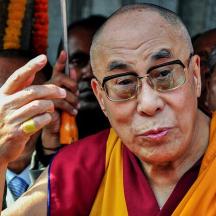 an older man wearing glasses and a robe