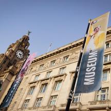 a building with a clock tower and a banner on it