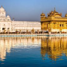 a large building with a reflection in the water