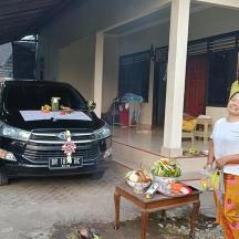 a woman standing in front of a car with a table